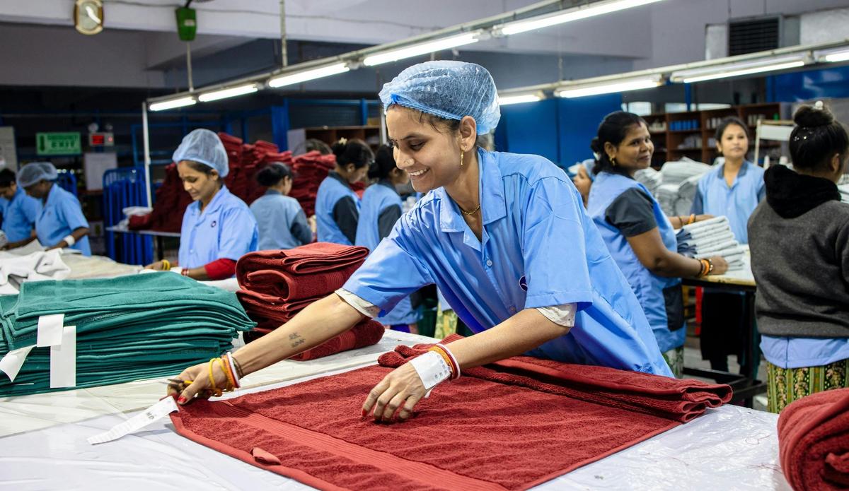 Textile factory workers folding towels