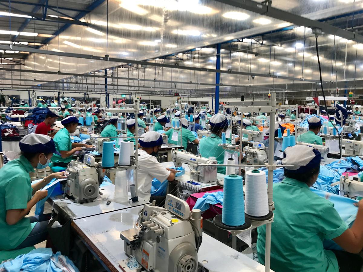 lines of factory workers sewing garments